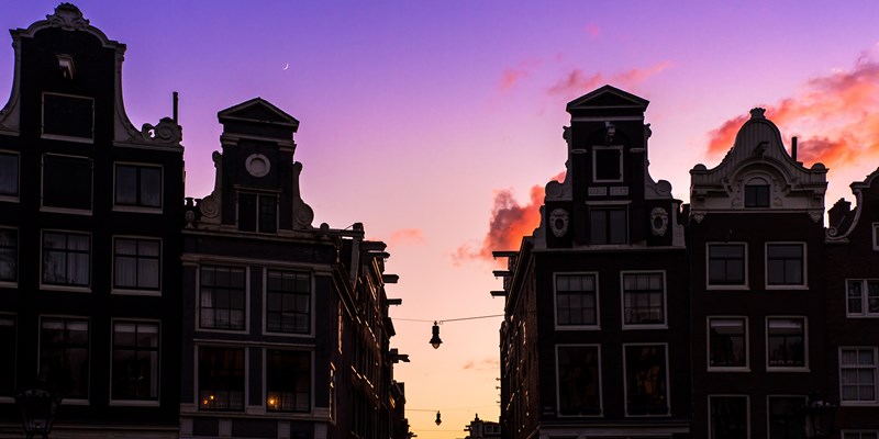Beautiful silhouettes of canal houses at the little nine streets in Amsterdam, the Netherlands, at sunset
