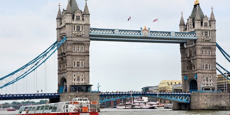 Sunset view of cruise ship at Thames river in London seen from Tower Bridge. England